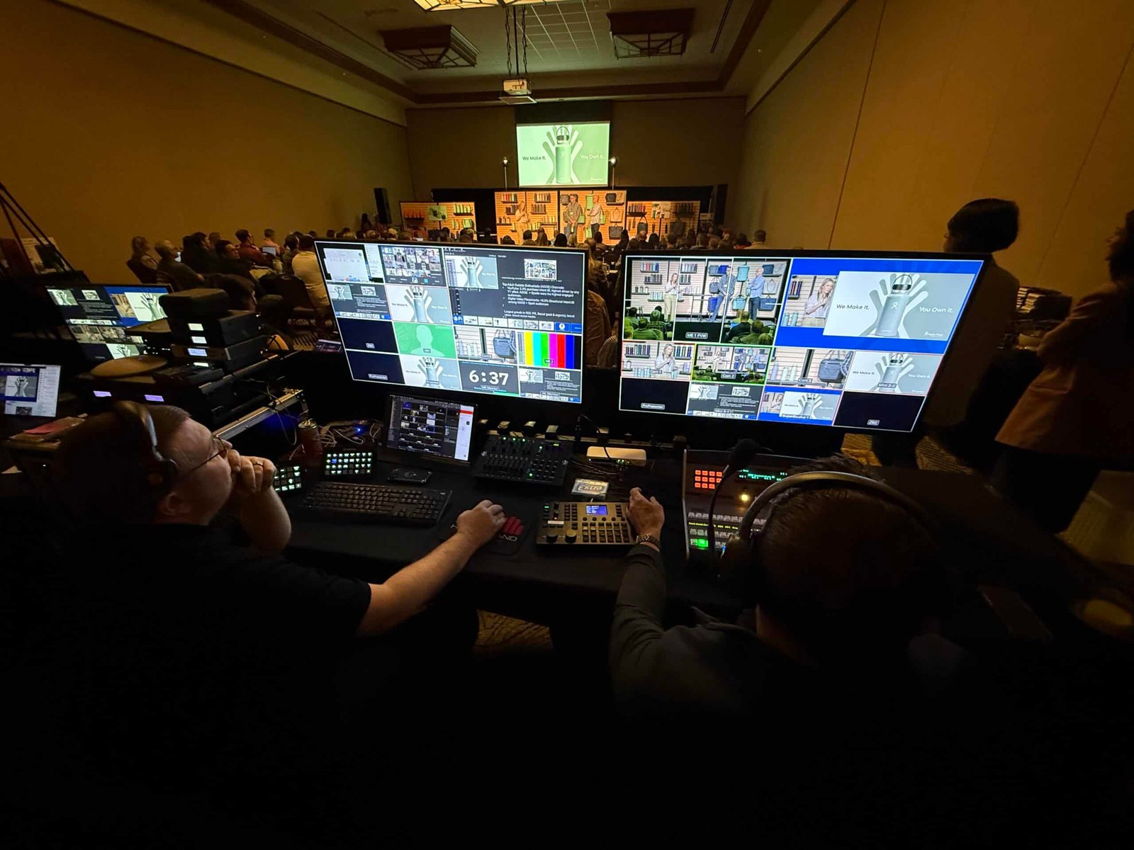 Hand in Hand Productions crew at the production desk managing live switching and audio for a packed corporate event in Bend, Oregon" — keyword-rich for the Corporate Events page